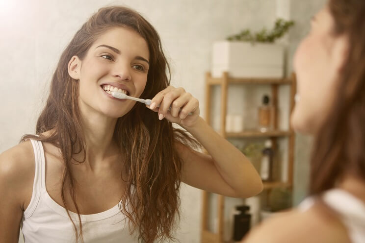 woman brushing teeth