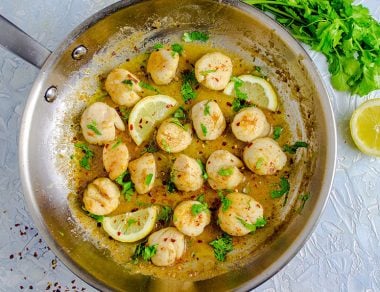 Seared scallops with herb-infused lemon butter sauce will melt in your mouth. All you need is ten minutes and a handful of ingredients.