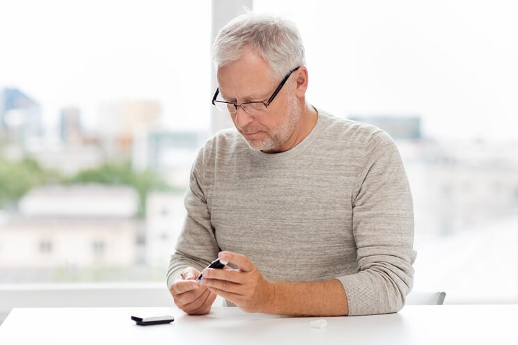 man checking blood sugar