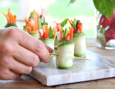 Stuffed with the raw, fresh veggies, these light zucchini roll-ups get a herby kick from the rich basil pesto.