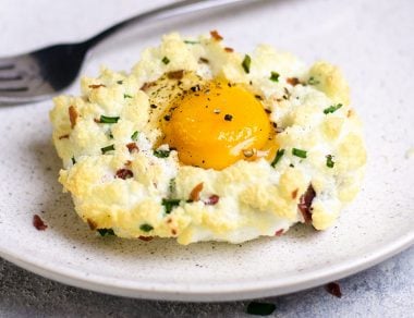 Fluffy eggs in clouds with oozy yolks! The light and airy egg white base has a whipped marshmallow-meets-meringue texture for a unique twist on baked eggs.
