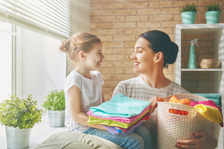 family folding clothes together