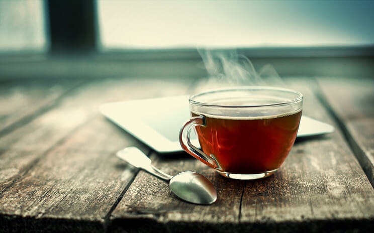 steaming darjeeling tea with a spoon