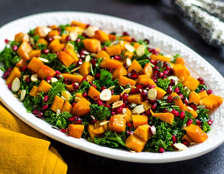 Tender kale greens get tossed with caramelized butternut squash for a hearty salad filled with nourishing ingredients.