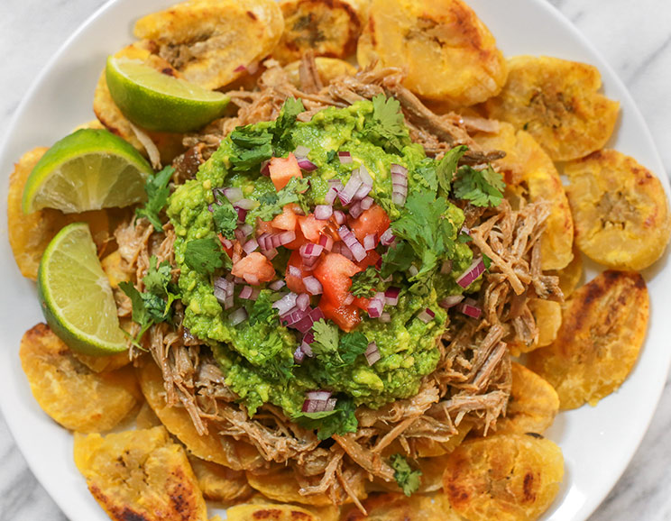 For a Paleo twist on nachos, dig into these crispy plantain slices topped with pulled pork and guacamole.