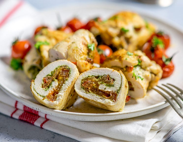 Roll up savory chicken breast around fresh basil pesto and juicy tomato for a dinner bursting with Tuscan flavors.