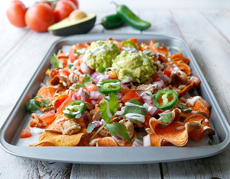 Get your snack on with these sweet potato nachos topped with spicy ground turkey, sliced jalapeños, and swirls of dairy-free sour cream.