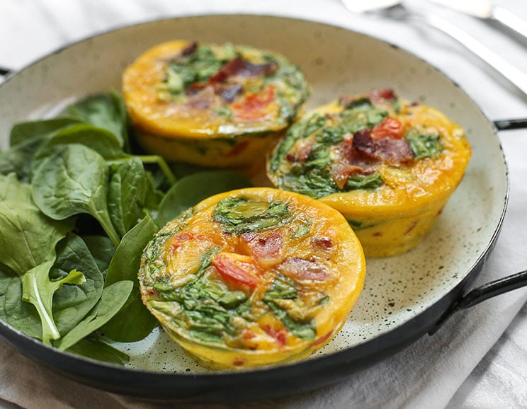 These individual-sized egg muffins are chock full of bacon and spinach for a satisfying, portable breakfast.