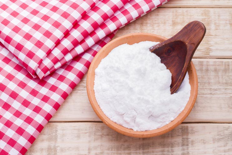 Baking-soda-in-a-bowl-with-spoon-and-dough-cloth.jpg