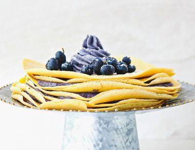 Add a dreamy twist to your breakfast with this Paleo Crêpes Cake recipe stacked with layers of blueberry filling.