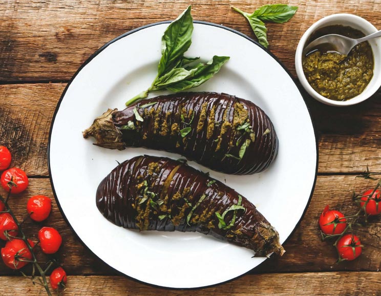 Thinly sliced eggplant gets stuffed with antioxidant-rich pesto and baked for a tender side dish full of fresh Mediterranean flavors.