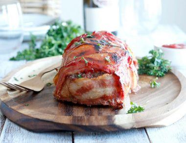 Savory meatloaf gets wrapped in smoky bacon and slathered with Paleo ketchup for a meal your family will love.
