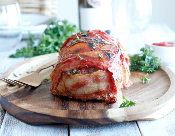 Savory meatloaf gets wrapped in smoky bacon and slathered with Paleo ketchup for a meal your family will love.