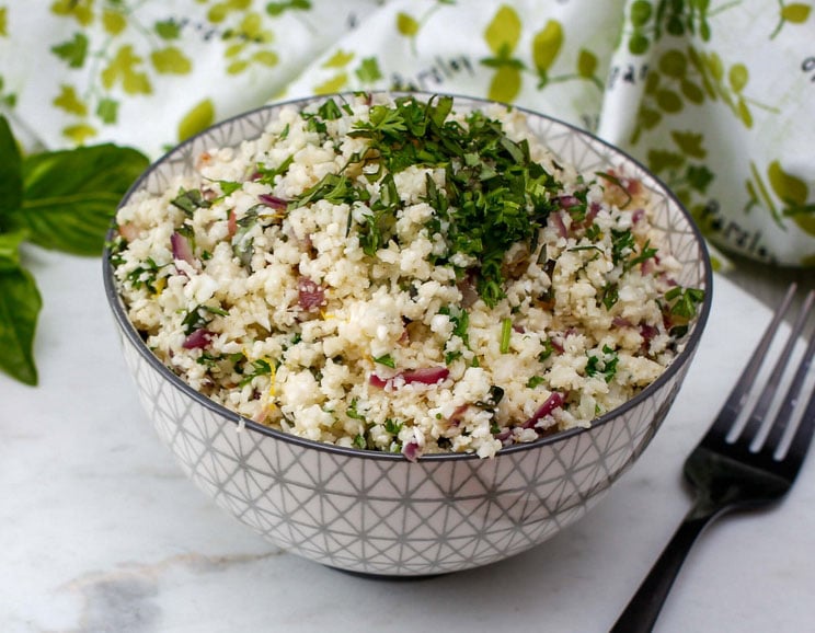 Zest up your dinner menu with this grain-free Lemon and Herb Cauliflower Rice. Grains don't stand a chance with this one.