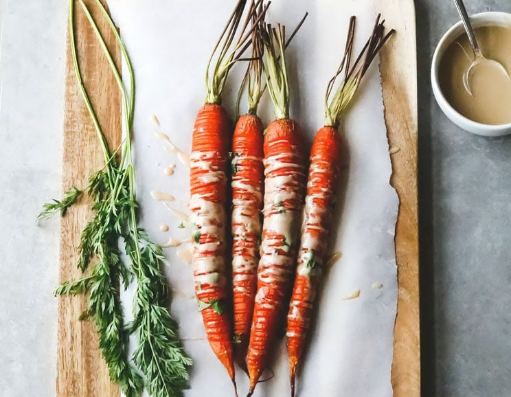 Toss these Hasselback Carrots with rich tahini and coconut aminos for a savory-sweet veggie dish. Orange is the new snack.