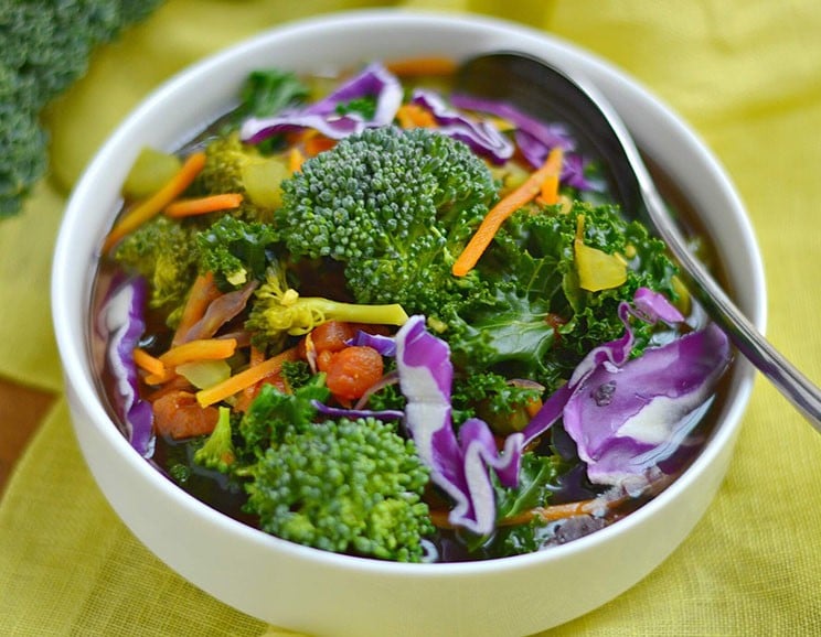 This vibrant, immune-boosting detox vegetable soup recipe has a rainbow of veggies and herbs, including cabbage, kale, and anti-inflammatory turmeric.
