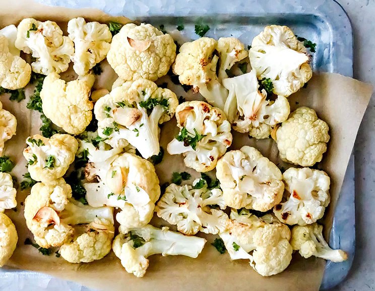 Boost your gut health with this Roasted Garlic Cauliflower, complete with cancer-fighting nutrients. Cauliflower never looked so good.