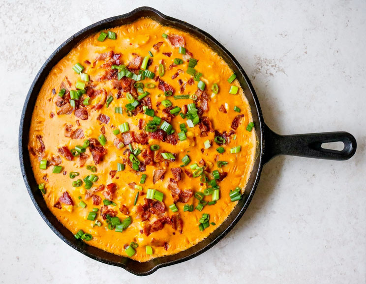 Double bake this keto cauliflower casserole in a dairy-free cheese sauce with smoky bacon and chopped green onions!