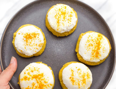 Bake up these golden turmeric cookies made with gluten-free flour and coconut cream icing. Half cookie, half cake, and none of the guilt!