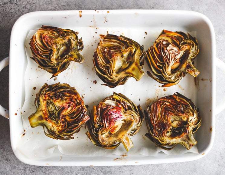 Easily roast up artichokes with melted ghee, lemon, and fresh herbs for a savory 6-ingredient appetizer!