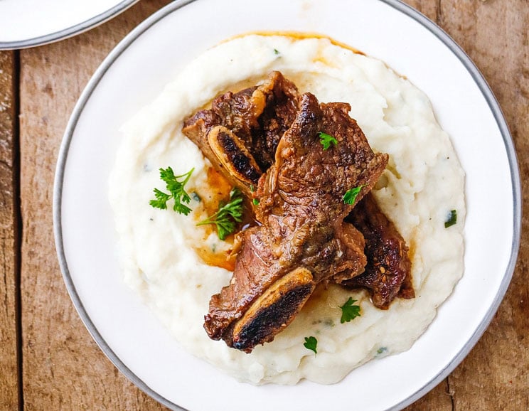 Enjoy a hearty meal with these fall-off-the-bone short ribs, slow-cooked in a savory broth of herbs, tomato paste, and coconut aminos.