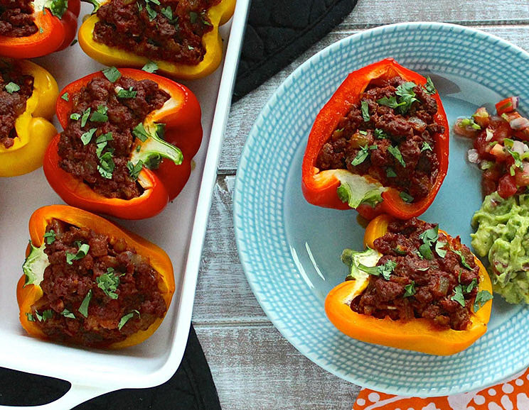Bell peppers are stuffed with spicy ground beef and topped with avocado in these unique Mexican stuffed peppers recipe!