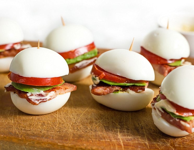 Snack on a bite-sized keto burger made with egg buns for a protein-packed snack. Fill them up with tomato, mayo, avocado, and bacon.