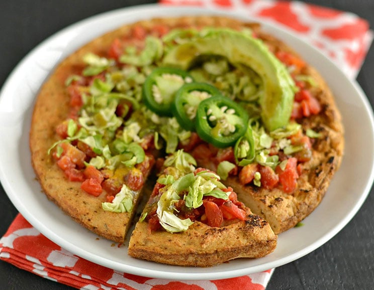 This avocado-topped tamale pizza is your new dinnertime game changer. Pile on all your favorite Mexican-inspired toppings and seasonings for an easy meal!