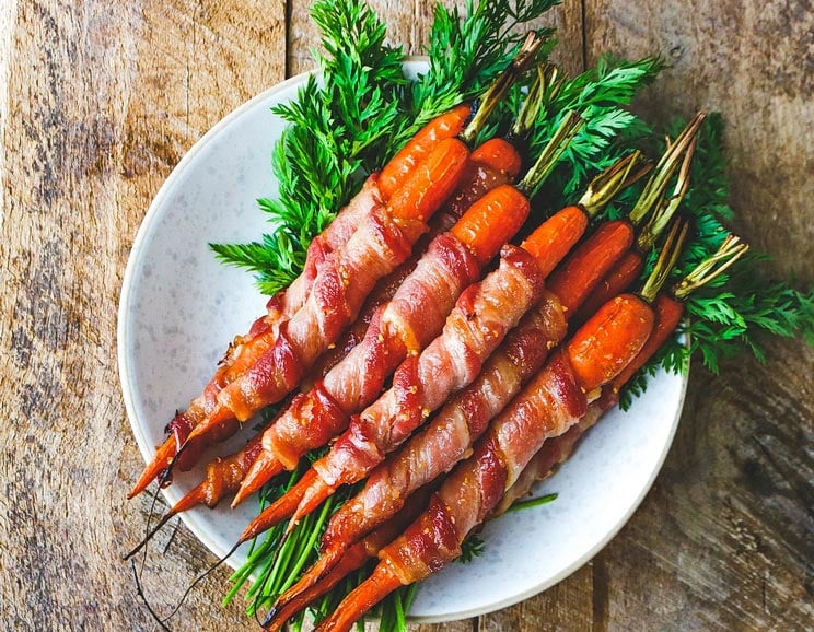 Wrap your carrots in bacon and slather them with a glaze that’s both savory and sweet. You're 4 ingredients away from side dish decadence.