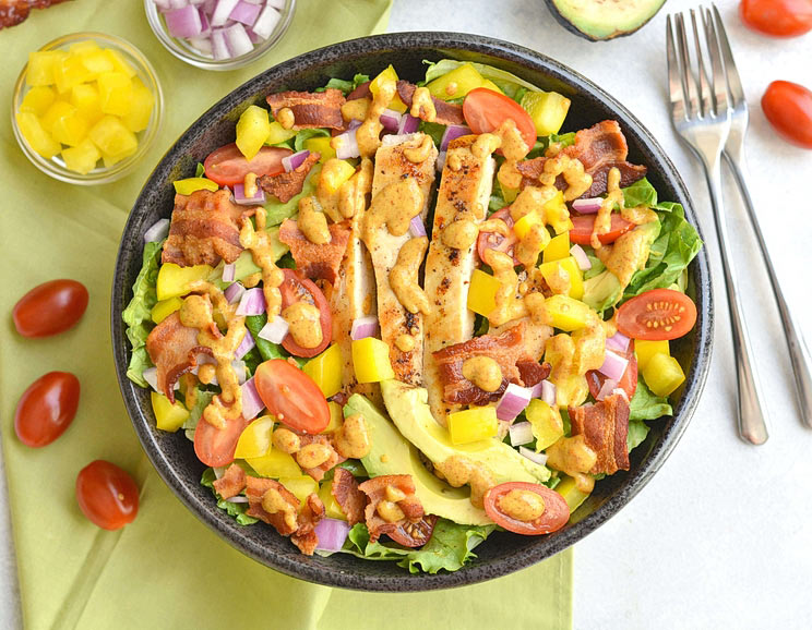 Take your salad up a notch with this epic bacon chicken salad loaded with a rainbow of veggies and topped with an easy 4-ingredient dressing.