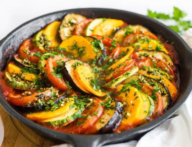 Roasted ratatouille is made with ultra-thin slices of tomato, eggplant, zucchini and butternut squash for a colorful meal that’s both vegan and Paleo!