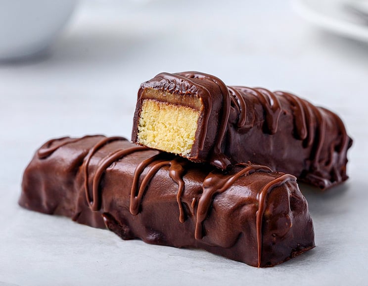 This Twix bar recipe uses a coconut flour shortbread, and has a creamy caramel sauce sandwiched between the cookie and chocolate.