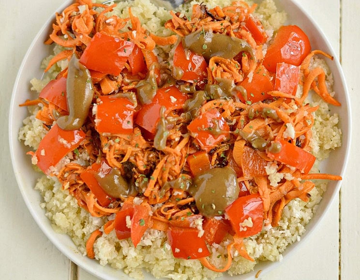 Give your favorite vegetables a spicy kick with this bold cauliflower rice dish topped with spicy almond sauce! A 30-minute meal that’s vegan and Paleo.