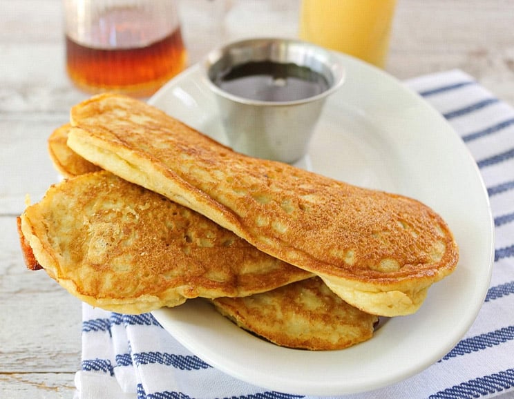 Jazz up breakfast with these handheld coconut flour bacon pancakes filled with crispy strips of bacon. Perfect for dunking in maple syrup!