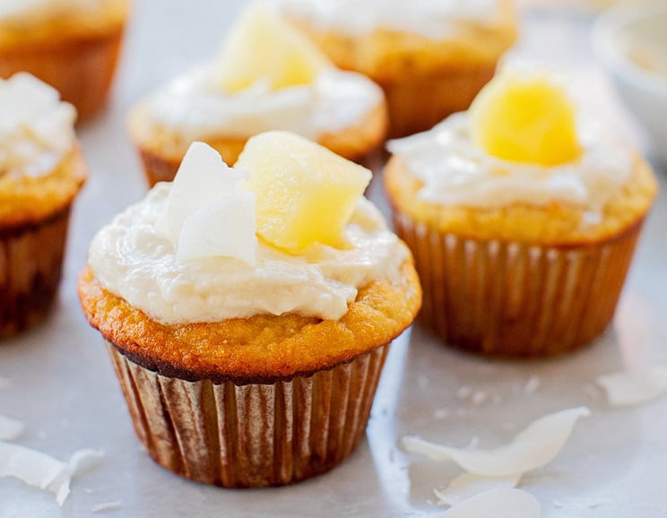These sweet Pina Colada Muffins are a refreshing treat. A light, satisfying dessert that will transport you to the beach with every bite!