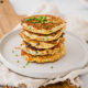 Start your morning with savory zucchini pancakes filled with bites of crunchy bacon and fresh chives! They're packed with protein, fiber and healthy fat.