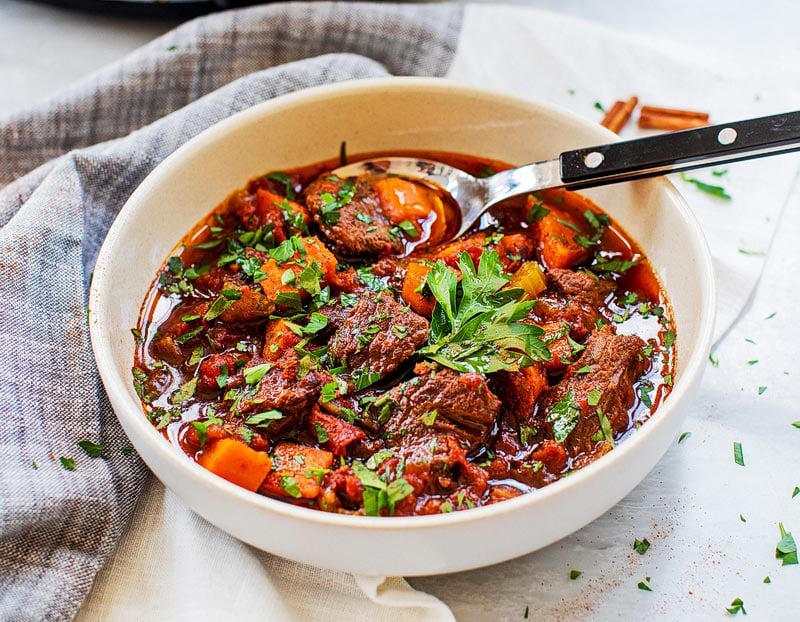 Settle in with a warm bowl of hearty beef tagine slow cooked in Moroccan spices and herbs for a hearty and nourishing meal.