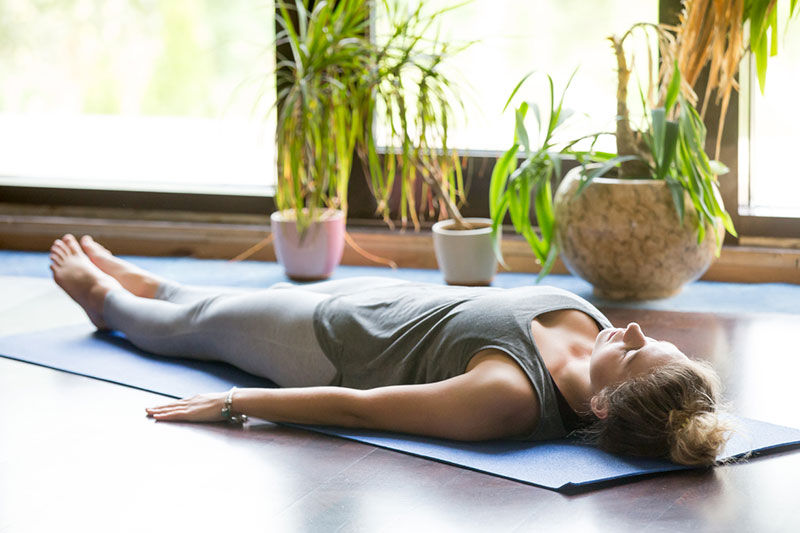 Woman working out at home, doing yoga exercise