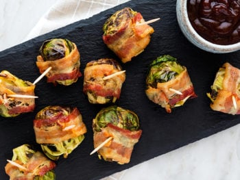 Getting ready to host a holiday party? Then you'll love this bacon-wrapped Brussel sprouts recipe. It's perfect for Paleo party trays or as a savory appetizer before dinner.